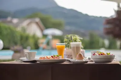 a table topped with plates of food and drinks at Hotel Sonnenhof in Lana