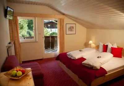 a bedroom with a bed and a window at Pension Lärchenhof in Naturno