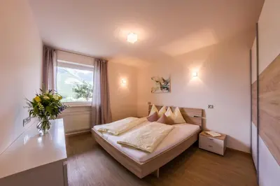 a hotel room with a bed and a window at Pension Verdinserhöhe in Schenna
