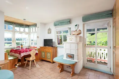 a living room with a table and a dining room at Kristiania in Campitello