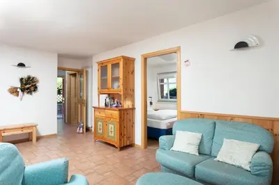 a living room with a couch and a chair at Kristiania in Campitello