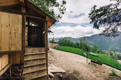 a wooden cabin on a hill with a view at Baumgartnerhof MÜLLER THURGAU in Cortaccia