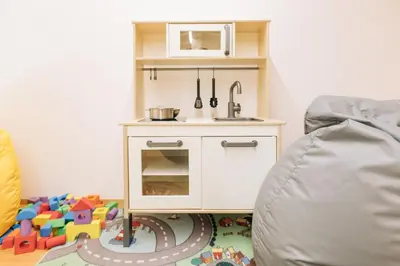 a toy kitchen with a sink and a toy track at Baumgartnerhof MÜLLER THURGAU in Cortaccia