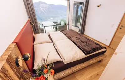 a bed in a room with a large window at Baumgartnerhof BLAUBURGUNDER in Cortaccia