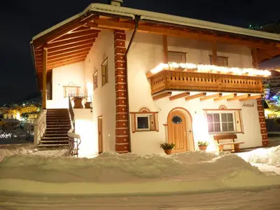 a small house in the snow at night at Artitsch in Santa Cristina in Val Gardena