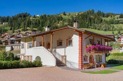 a house on a hill with a mountain at Artitsch in Santa Cristina in Val Gardena