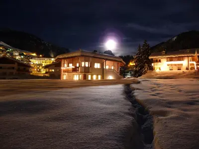 a building in the snow at night at Artitsch in Santa Cristina in Val Gardena