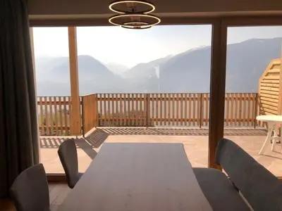 a table and chairs on a balcony with a view at Ferienwohnungen Oberweier in Merano