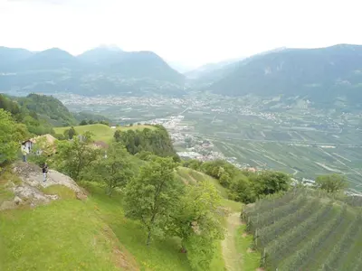 a person standing on a hill looking at a valley at Ferienwohnungen Oberweier in Merano