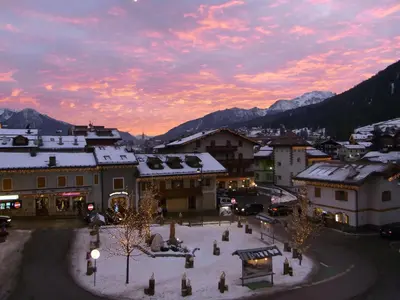 a view of a town with snow covered buildings at Casa Elisa in Pozza di Fassa