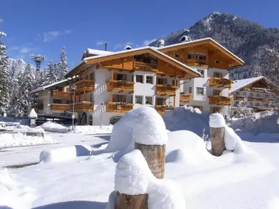a building covered in snow in front at Casa Elisa in Pozza di Fassa