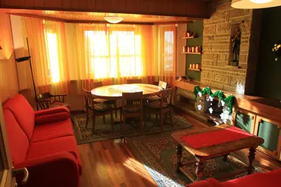 a living room with a table and chairs at Casa Elisa in Pozza di Fassa