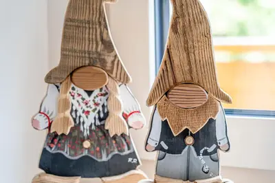 a pair of wooden figurines of a woman wearing a dress at Blizzard apartments in Arabba