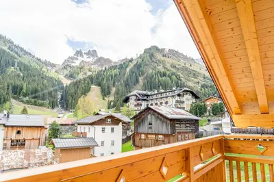 a view from a balcony of a village in the mountains at Blizzard apartments in Arabba