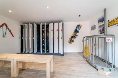 a room with a bunch of skateboards on a wall at Blizzard apartments in Arabba