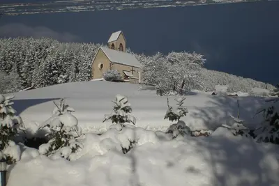a church on a hill covered in snow at Gasleidhof in Funes