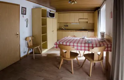 a bedroom with a bed with a light on the wall at Appartamenti Bel Sit in Canazei
