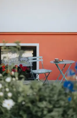 a building with a balcony with flowers on it at Residence Obermoarhof - Family Apartments with Pool & Playground in Vandoies