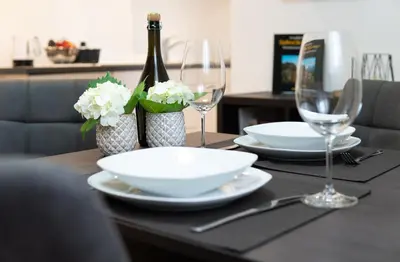 a table with two glasses and a bottle of wine at Apartment Hanna in Merano
