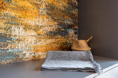 a blanket on a table in front of a painting at Apartment Hanna in Merano