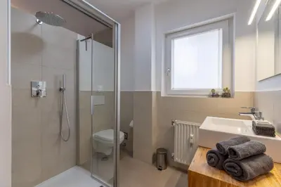 a bathroom with a shower and a sink and a toilet at Apartment Hanna in Merano