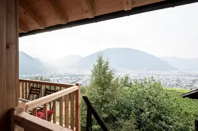 a view from the deck of a cabin with a view of the mountains at Kristplonerhof in Bolzano