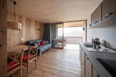 a kitchen and living room with a couch and a table at Kristplonerhof in Bolzano