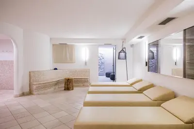 a living room with a row of couches at Hotel Hurtmuehle Kronblick in San Lorenzo di Sebato