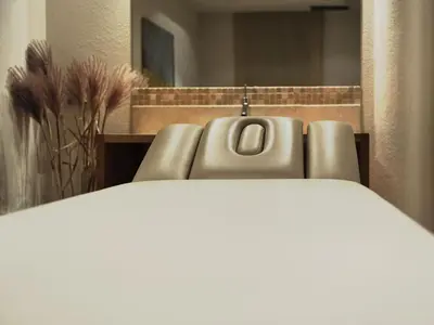 a close up of a couch in a room with a mirror at Hotel Hurtmuehle Kronblick in San Lorenzo di Sebato