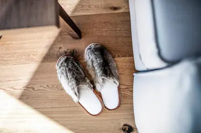 a pair of shoes sitting on a wooden floor at Aparthotel Panorama Living Dolomites in Maranza