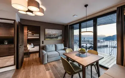 a living room with a couch and a table at Aparthotel Panorama Living Dolomites in Maranza