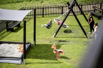 a group of children playing in a playground at Aparthotel Panorama Living Dolomites in Maranza