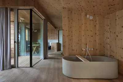 a bathroom with a tub in the middle of a room at Odles Lodge in Bressanone