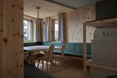 a dining room with a table and chairs at Odles Lodge in Bressanone