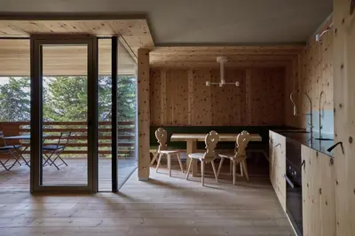 a kitchen and dining room with a table and chairs at Odles Lodge in Bressanone