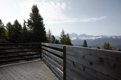 a wooden fence with mountains in the background at Odles Lodge in Bressanone