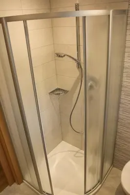 a shower with a glass door in a bathroom at Appartements Pixner in Saltusio