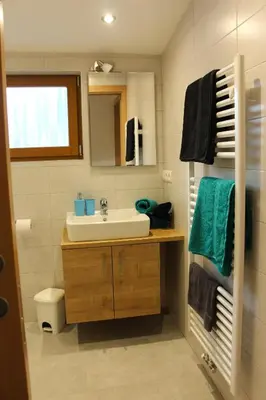 a bathroom with a sink and a mirror at Appartements Pixner in Saltusio