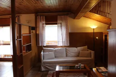 a living room with a couch and a table at Cesa DOLOMITI in Rocca Pietore