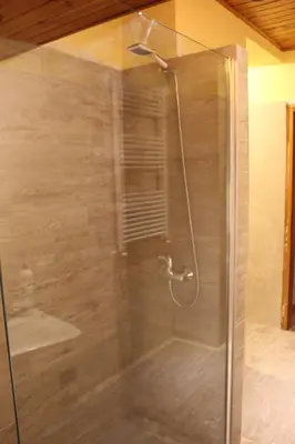 a shower with a glass door in a bathroom at Cesa DOLOMITI in Rocca Pietore