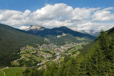 a town in the middle of a valley with mountains at Hotel Talblick in Ortisei