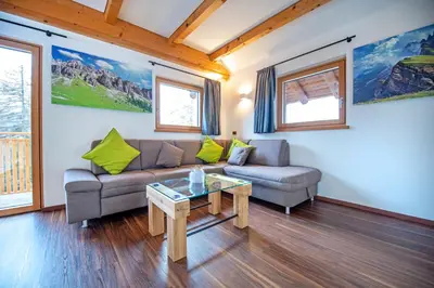 a living room with a couch and a table at Chalet Aghel in Santa Cristina in Val Gardena