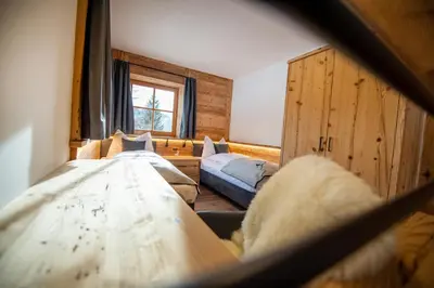 a bedroom with two beds and a window at Chalet Aghel in Santa Cristina in Val Gardena