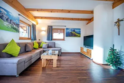 a living room with a couch and a christmas tree at Chalet Aghel in Santa Cristina in Val Gardena
