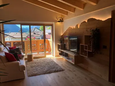 a living room with a couch and a fireplace at Cèsa Prinoth in Campitello di Fassa