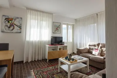 a living room with a couch and a table at Casa Faloria in Cortina dʼAmpezzo