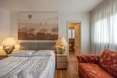 a bedroom with a bed and a couch at Casa Faloria in Cortina dʼAmpezzo