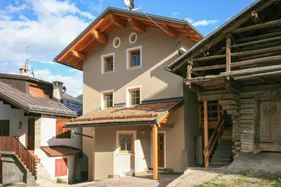 a house with a wooden roof at Casa Piccolin in Falcade