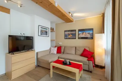 a living room with a couch and a tv at Apartments Irene in La Villa