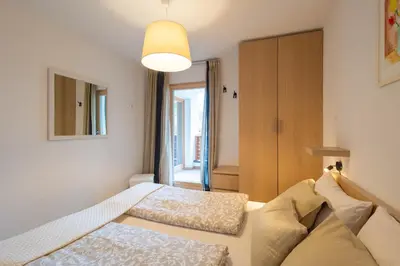 a bedroom with two beds and a large window at Apartments Irene in La Villa